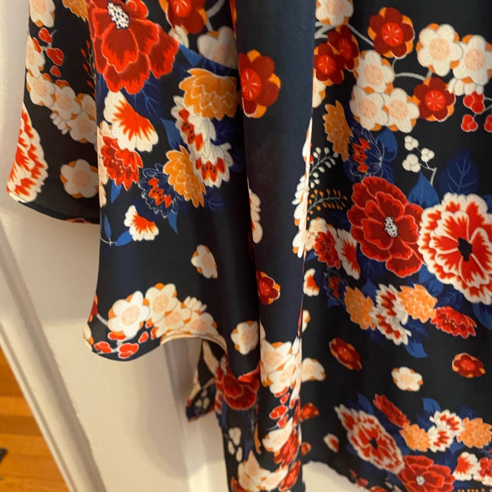 Blue blouse with bell sleeves. Pretty flowers. Soft fabric. Gently used.
